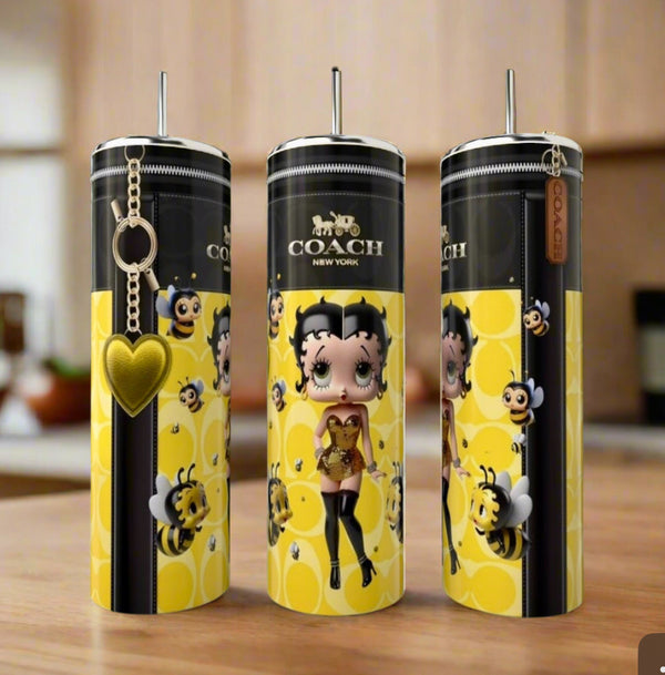 Three tall Kreative Kreationz Betty Boop | Yellow 20oz Tumblers feature cartoon Betty Boop with a bee, surrounded by bees, honeycomb patterns, and a yellow heart keychain—a stylish luxury-inspired addition to any kitchen.