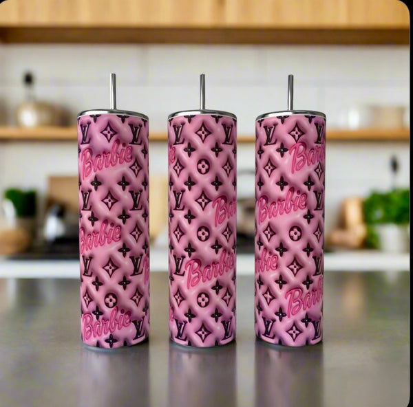Three tall Barbie LV 20oz Tumblers by Kreative Kreationz stand on a counter, each with metal straw and a chic pattern blending Barbie and Louis Vuitton symbols. The softly blurred kitchen background adds an elegant touch.