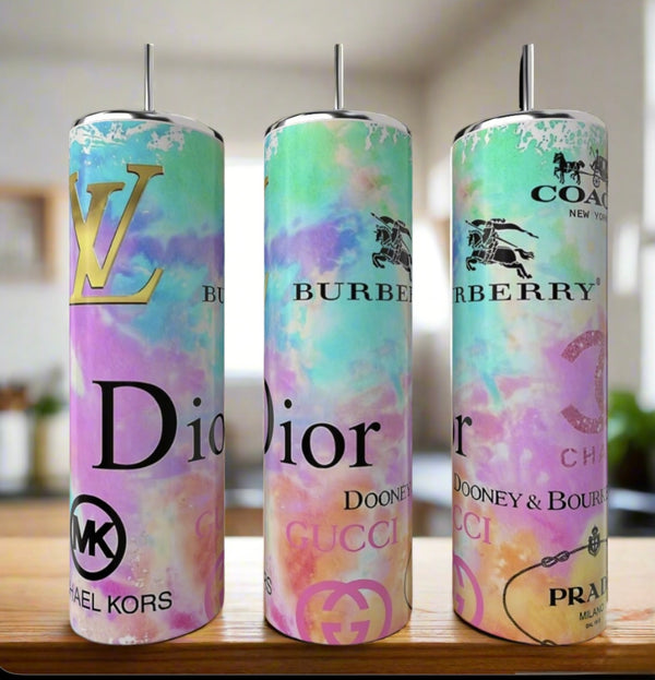 Three 20oz Designer Tumblers by Kreative Kreationz, featuring pastel tie-dye designs and luxury-inspired logos, are shown with straws on a wooden surface.