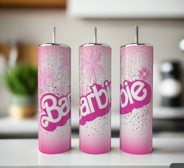 Three Kreative Kreationz Barbie 20oz Tumblers, featuring pink and white designs with bold “Barbie” lettering, sparkles, stars, silver lids, and straws, are shown on a white countertop in a modern kitchen.