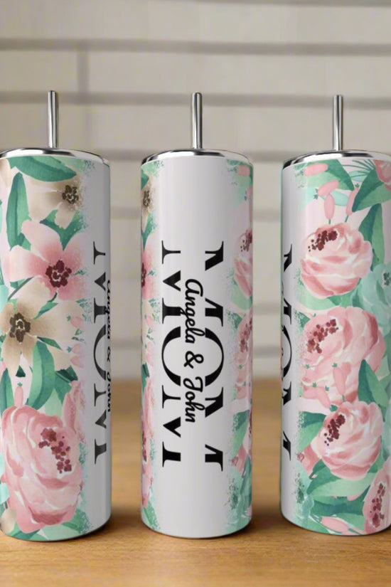 Three tall Kreative Kreationz MOM 20oz Tumblers with pastel floral designs rest on a wooden surface. The center tumbler reads 