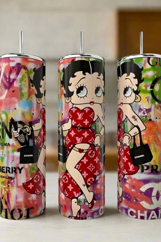 The Betty Boop Diva 20oz Tumbler by Kreative Kreationz features three tall stainless steel tumblers with colorful graffiti backgrounds, showing Betty Boop in red and luxury-inspired designs with iconic brand logos.
