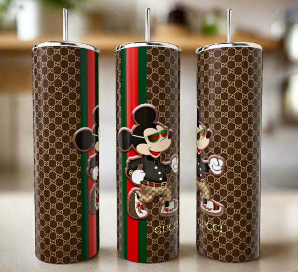 The Mickey Mouse GUCCI 20oz Skinny Tumbler by Kreative Kreationz features a brown Gucci-inspired pattern, red-green stripes, and a stylish cartoon mouse—perfect luxury drinkware for any trendsetter.