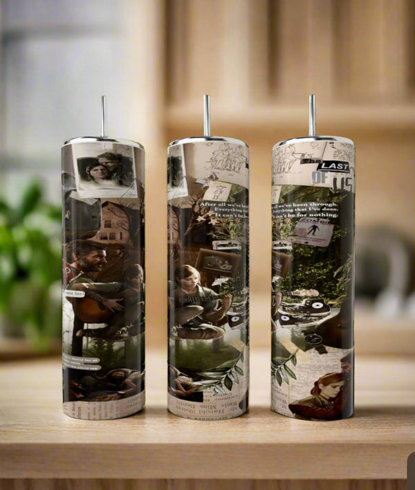 Three 20oz Skinny Tumblers by Kreative Kreationz, featuring The Last Of Us game collage artwork in muted earth tones, sit on a wooden surface with a blurred kitchen background. Each eco-friendly tumbler includes a metal straw.