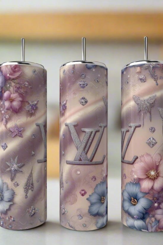 Three tall, cylindrical 20oz stainless steel tumblers from Kreative Kreationz feature Louis Vuitton-inspired pastel designs with florals, diamond shapes, and 