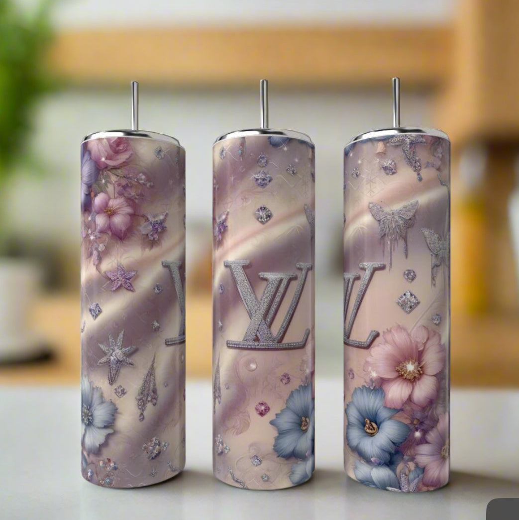 Three tall, cylindrical 20oz stainless steel tumblers from Kreative Kreationz feature Louis Vuitton-inspired pastel designs with florals, diamond shapes, and "LV" initials—stylish luxury drinkware for any occasion.