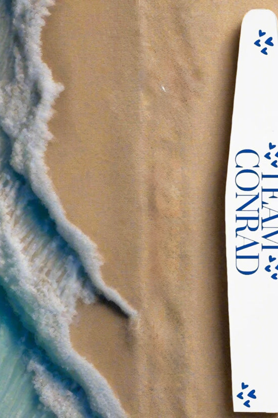 A white surfboard with blue paw prints and 