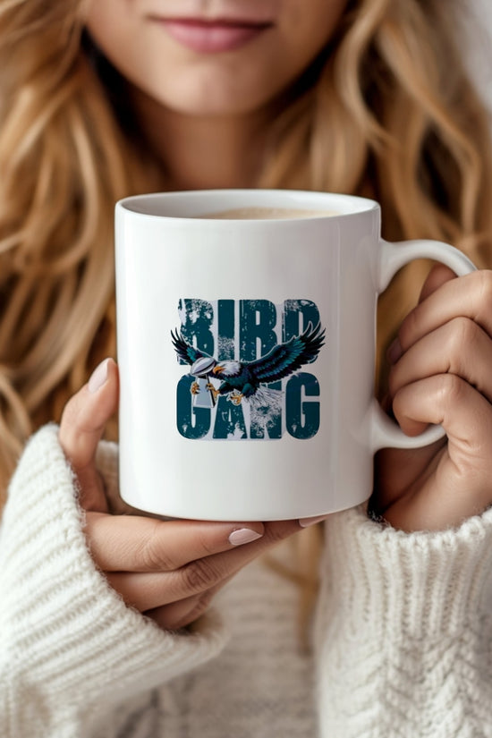 A woman in a white sweater holds the 11oz 