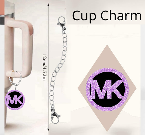 The MK Cup Charm by Kreative Kreationz is a handcrafted tumbler accessory with a glittery pink "MK" logo on a silver chain. Measuring 12cm (4.72 inches), it elegantly hangs from your cup's handle against a minimalist background.