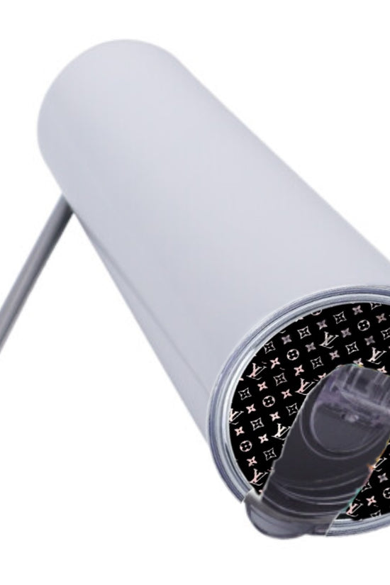The 20oz Tumbler Topper by Kreative Kreationz is a white stainless steel skinny tumbler with a clear flip-top lid and metal straw. The Lid Topper's underside features a black pattern with white 