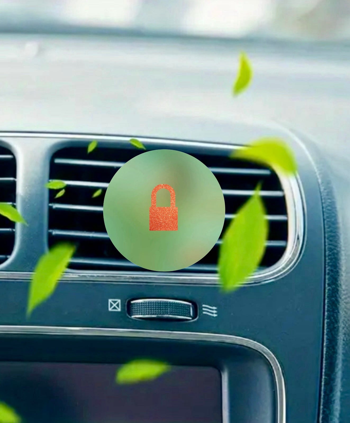Close-up of a car dashboard air vent with green leaves and a red padlock icon, illustrating the secure and refreshing effect of the TS12 Car Air Freshener by Kreative Kreationz.