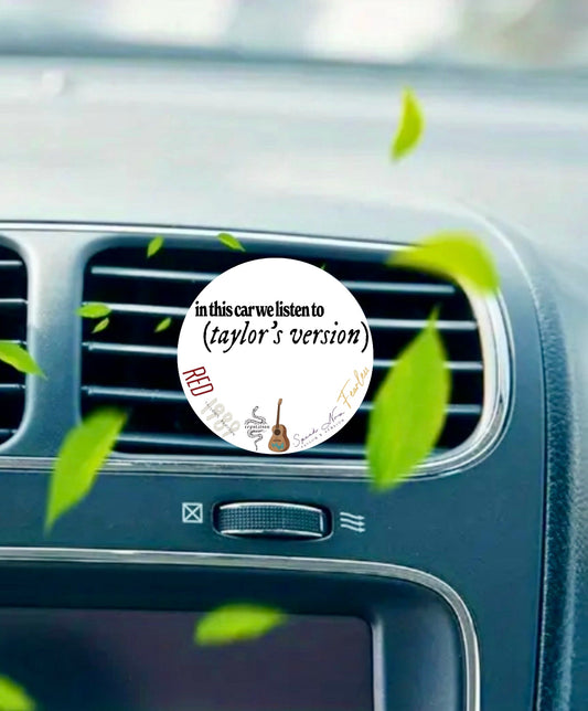 The Kreative Kreationz "In This Car We Listen To Taylors Version" air freshener clips to your car vent and features album doodles, a guitar, and green leaves for a fun touch.