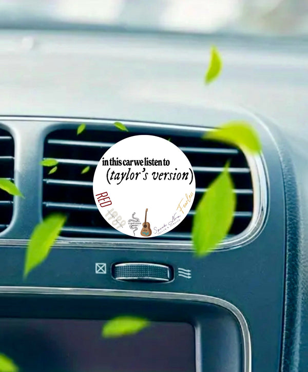 The Kreative Kreationz "In This Car We Listen To Taylors Version" air freshener clips to your car vent and features album doodles, a guitar, and green leaves for a fun touch.