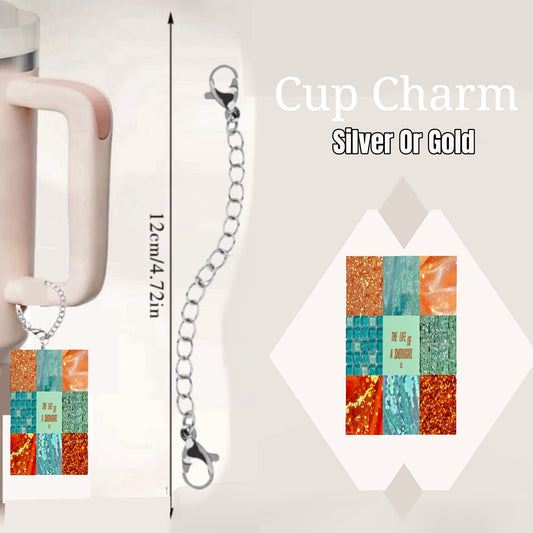 The Life of a Showgirl Charm Dangle by Kreative Kreationz is a cup accessory with a colorful rectangular pendant and lobster clasp silver chain (12cm/4.72in), attached to the handle. Inset highlights the unique charm design. Text: "Cup Charm Silver Or Gold.