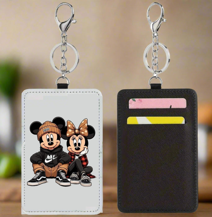 Two Mickey Nike Card Wallet keychains by Kreative Kreationz are shown. The front displays cartoon kids in Mickey and Minnie Nike outfits, while the back has three card slots, making it a fun and slim travel wallet.