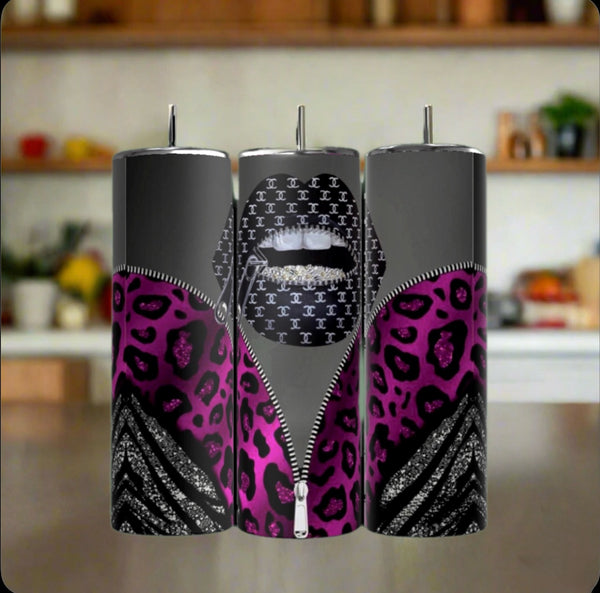 The Kreative Kreationz Louis Vuitton Zipper 20oz Tumblers feature spill-proof lids, a purple leopard and zebra pattern, lips with white teeth, and a repeating "C" design. A blurred kitchen is visible in the background.