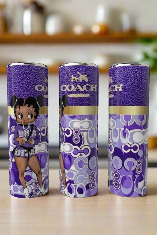 Three Boop Purple 20oz Tumblers by Kreative Kreationz, each featuring Betty Boop art, are displayed on a wooden surface with a blurred kitchen background.