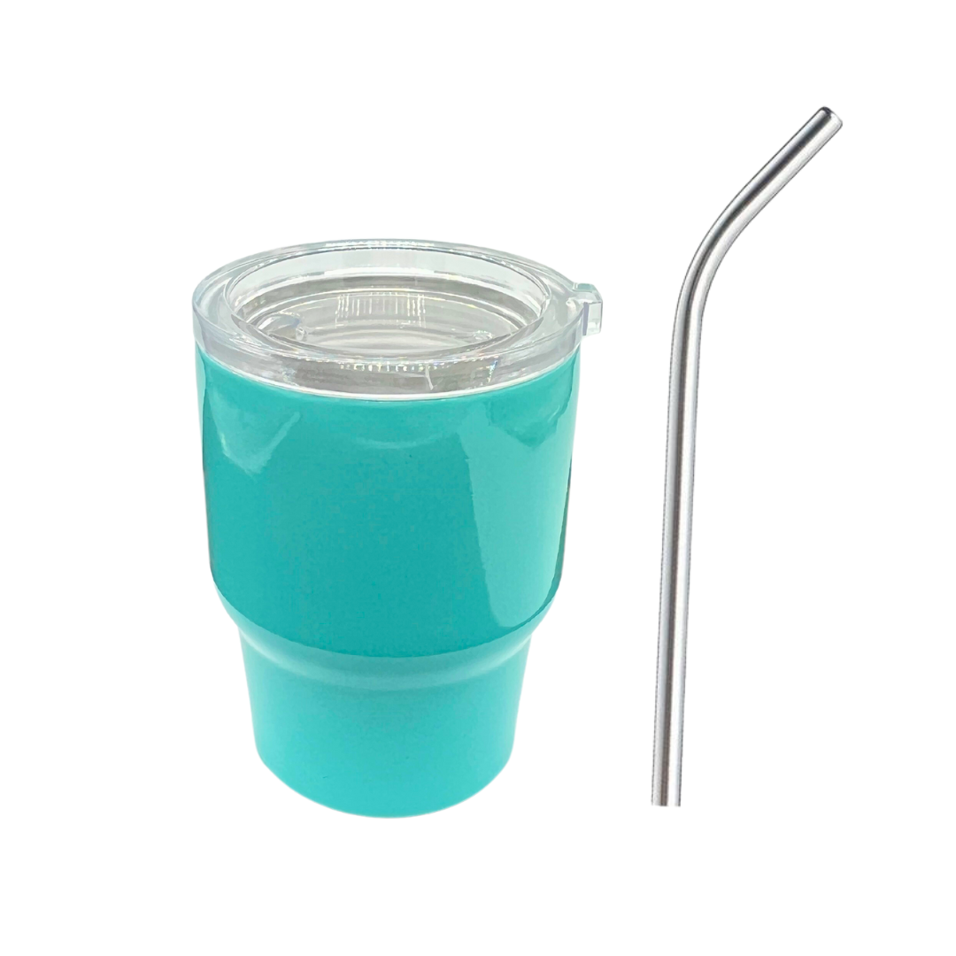 The Kreative Kreationz Shot Glass Tumbler in turquoise features a clear lid and sits beside a metallic reusable straw on a white background, highlighted by its sleek stainless steel accents for modern flair.