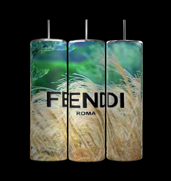 Three cylindrical Beach FENDI 20oz Skinny Tumblers by Kreative Kreationz feature double-wall insulation. The center tumbler displays "FEENDI ROMA" in black. Each has a vibrant green and golden grass design, FENDI DESIGN logo, and a black cap, standing upright against a black background.