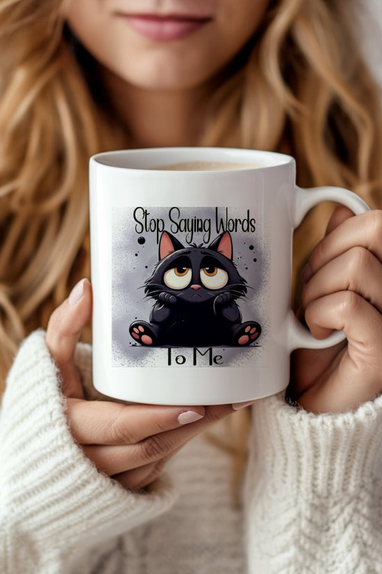 A woman in a cozy white sweater holds Kreative Kreationz’s Dont Talk To Me Mug, featuring a cartoon black cat and the phrase 