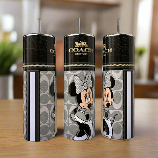Three Kreative Kreationz 20oz skinny tumblers, including the Mickey Mouse Coach design, are displayed on a wooden table with a blurred kitchen background, showcasing stylish and luxury drinkware.