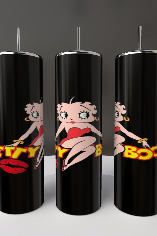 Three Betty B20oz Skinny Tumblers by Kreative Kreationz, featuring black cylinders with silver lids and a cartoon character in a red outfit and red lips, partially read 