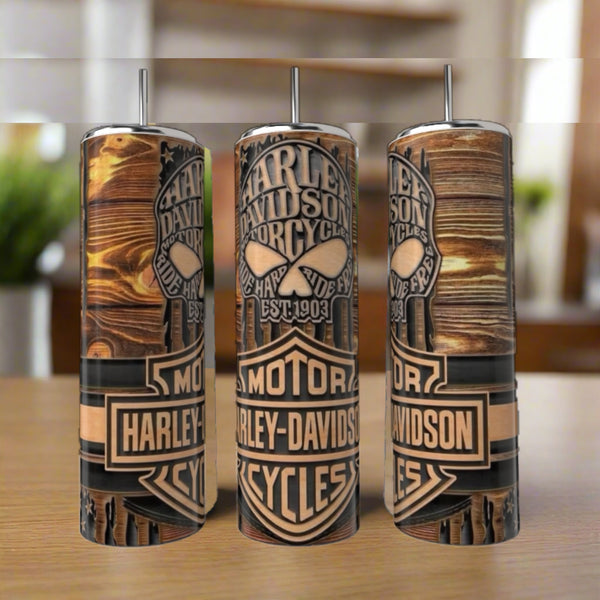 Three Harley Davidson 20oz Skinny Tumblers by Kreative Kreationz, each with double-walled stainless steel, vivid wooden plank designs, and Harley-Davidson logos, sit on a wooden surface against a blurred background.