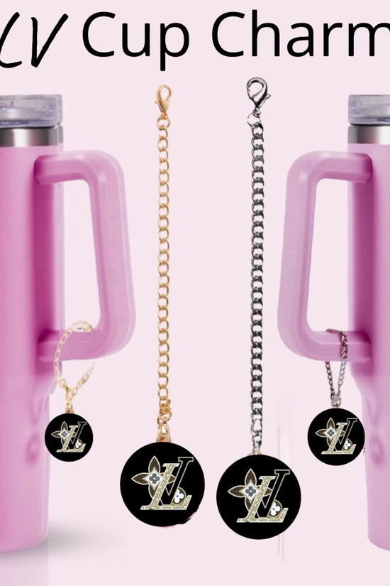 Two pink tumblers with handles, each adorned with a Kreative Kreationz LV Charm Dangle cup accessory—round black and gold charms on chains. 