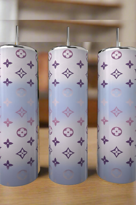 Three LV Pastel Inspired 20oz Tumblers by Kreative Kreationz, featuring gradient pastel blue and purple hues with monogram-style patterns, are displayed on a wooden surface—stylish, eco-friendly drinkware for any setting.