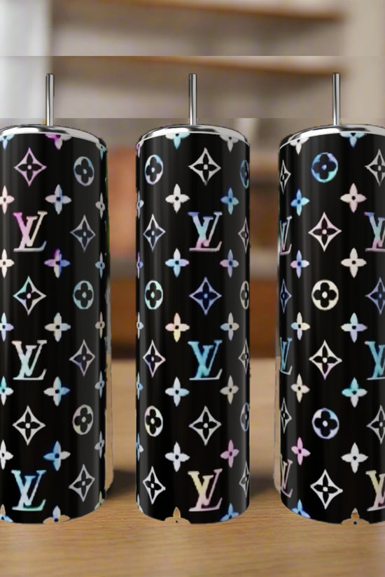 Three LV Inspired Multicolor 20oz Tumblers by Kreative Kreationz, each featuring a glossy black background with luxury-inspired patterns, are shown with metal straws on a wooden surface.