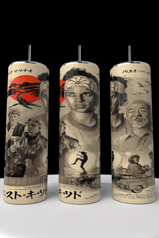 Three cylindrical candles feature vintage-style illustrations of martial artists, a car, and a crane against a sunset backdrop. The art is akin to that on the Kobra Kai 20oz Stainless Steel Tumbler by Kreative Kreationz, with text in Japanese characters.
