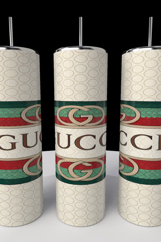 The Kreative Kreationz Gucci 20oz Tumbler showcases a repeating Gucci logo with green and red stripes on a dark background, keeping beverages hot or cold while captivating with its design.