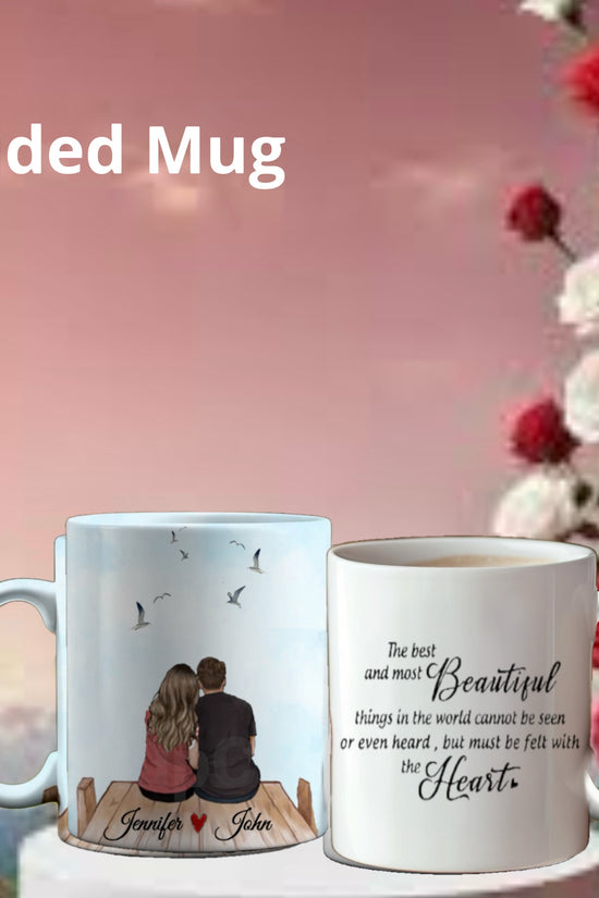 The Personalized Couples Ceramic Mug by Kreative Kreationz embodies a thoughtful gift, featuring a couple on a dock with birds, names personalized. The reverse displays a heartfelt beauty quote amid blooming red and white roses against a pink sky—a perfect personalized couples mug.