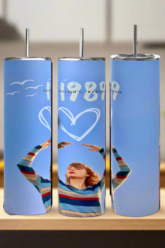 Three Taylor Swift 1989 20oz Tumblers by Kreative Kreationz, crafted from eco-friendly stainless steel, feature metal straws and unique designs: a person in a striped sweater, heart and bird graphics, plus 