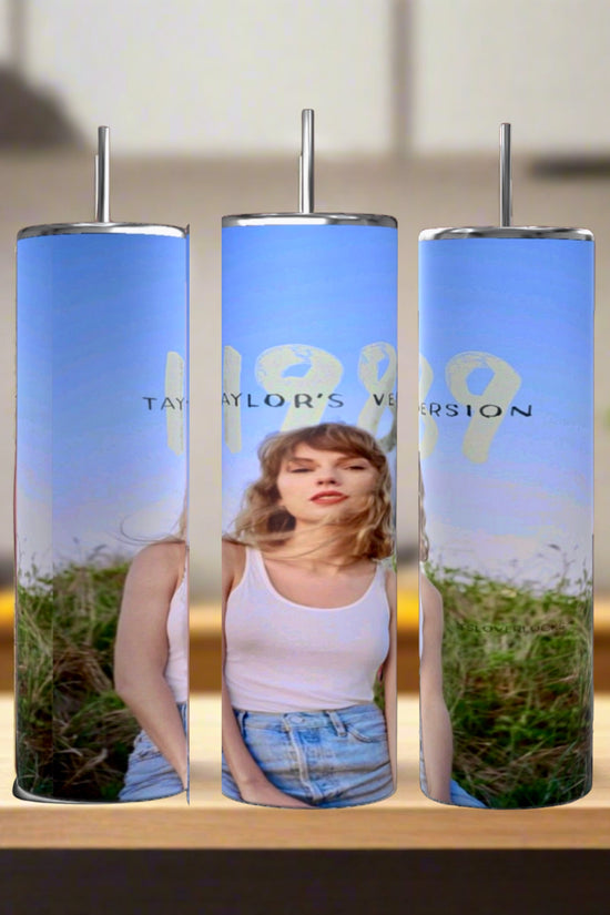 The Taylor Swift 1989 20oz Tumblers by Kreative Kreationz are eco-friendly, reusable and feature a photo of a woman in white tank top and denim shorts under blue skies with “1989 Taylor’s Version” text, each with a stainless steel straw.