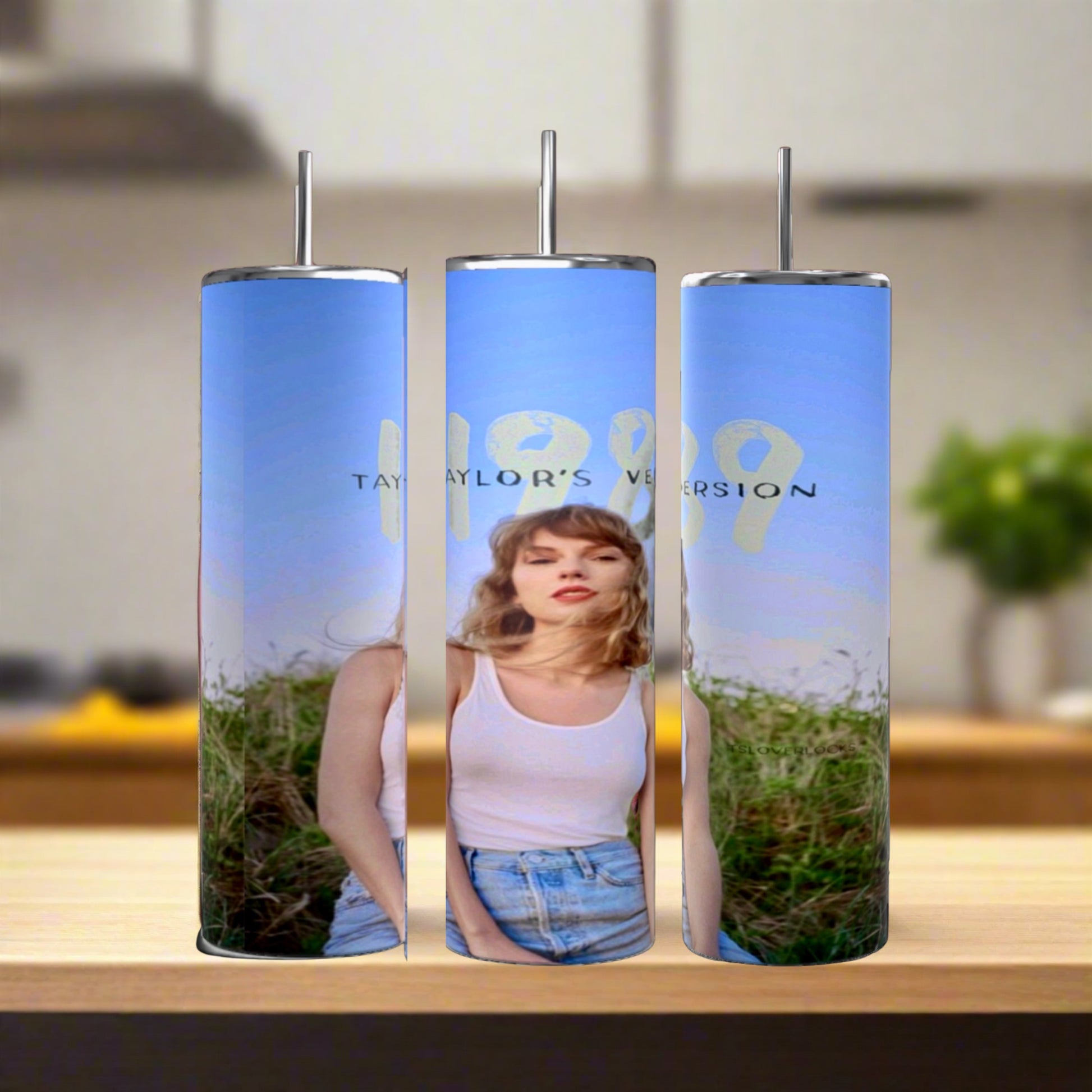 The Taylor Swift 1989 20oz Tumblers by Kreative Kreationz are eco-friendly, reusable and feature a photo of a woman in white tank top and denim shorts under blue skies with “1989 Taylor’s Version” text, each with a stainless steel straw.