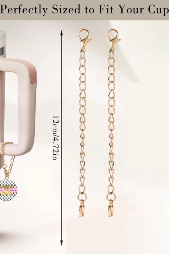 The Chanel Charm Dangle by Kreative Kreationz is a cream-colored cup accessory with a long handle and a golden chain featuring a personalized pendant. The image includes a measurement guide showing the 12 cm (4.72 inches) lobster clasp chain, described as 