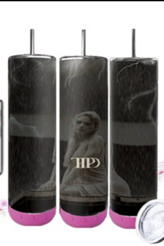 Three TTPD Bluetooth Tumblers by Kreative Kreationz, featuring a black cylindrical design with pink bases, are displayed. Each tumbler showcases a statue motif and the initials 