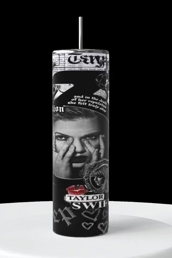 Video 1 tall cylinder a 20oz tumblers that turns in a counter clockwise position showing all sides of the sublimated image on the tumbler with a picture of Taylor Swift from her Reputation era inside the number 13, with other key phrases, text and song titles from the reputation album such a as “getaway car” “are you ready” “Taylor swift” 