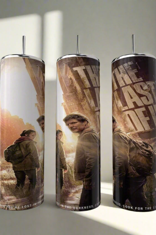 The Last Of Us Tumbler by Kreative Kreationz showcases two characters in outdoor gear amid a post-apocalyptic scene, with the TV series title boldly displayed. Set includes three stainless steel tumblers.